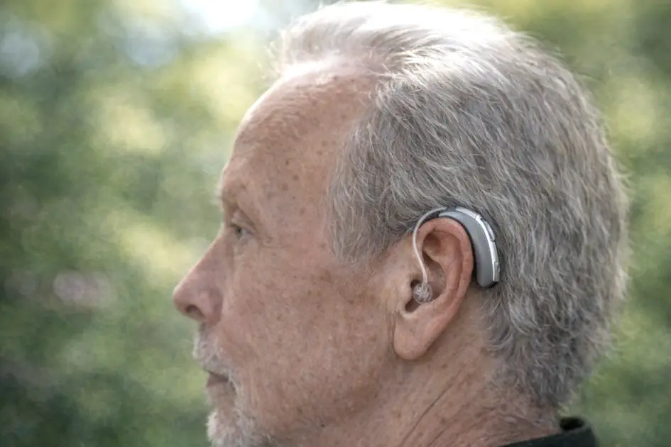 Outdoor portrait showing a small, natural-looking hearing aid device