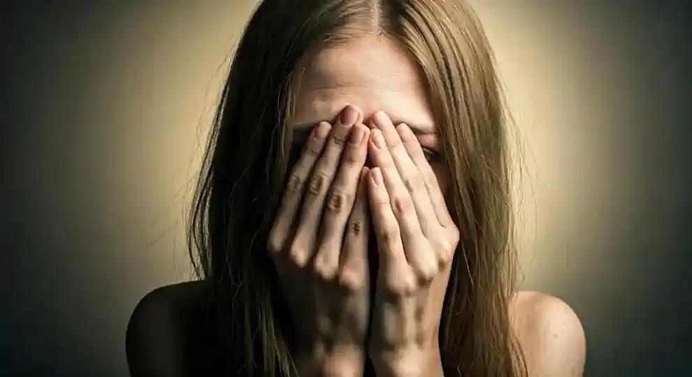 A troubled woman reflecting on health struggles